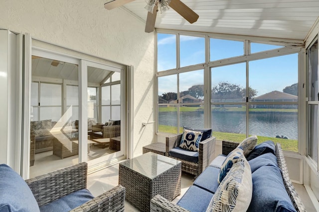 sunroom / solarium featuring a ceiling fan, lofted ceiling, and a water view