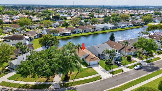 birds eye view of property with a water view and a residential view