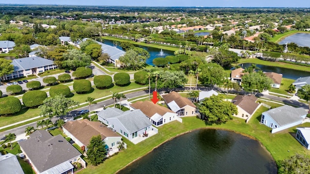 birds eye view of property with a water view and a residential view