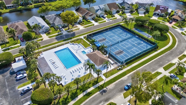 drone / aerial view featuring a water view and a residential view