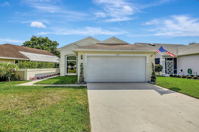 ranch-style house with a garage, a shingled roof, concrete driveway, a front lawn, and stucco siding