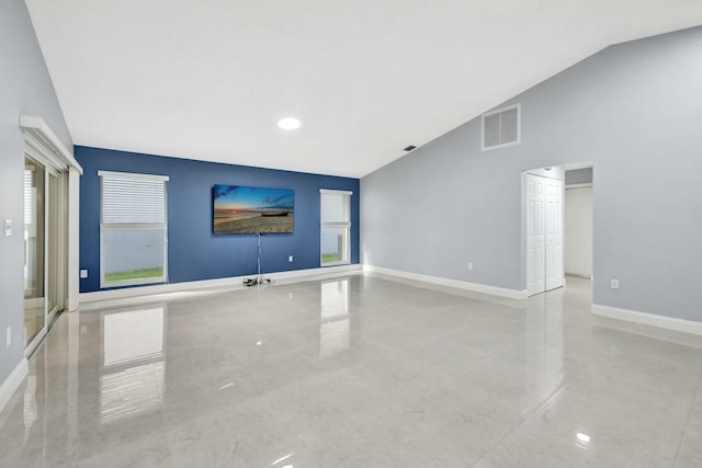 unfurnished living room with high vaulted ceiling, visible vents, and baseboards