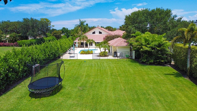 exterior space featuring a patio, a trampoline, and a fenced backyard