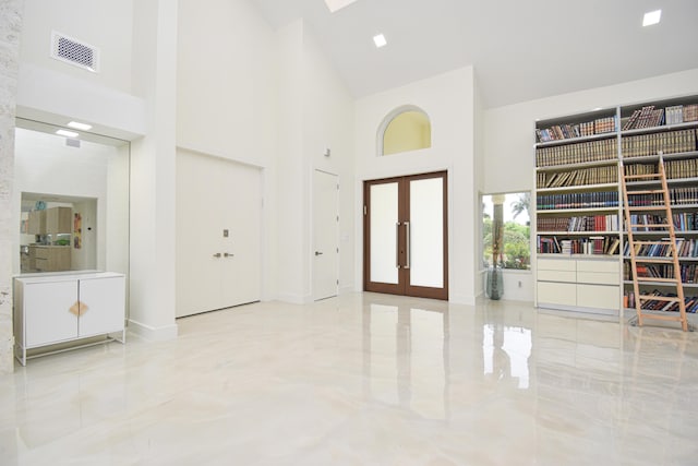 entryway featuring a high ceiling, french doors, visible vents, and baseboards