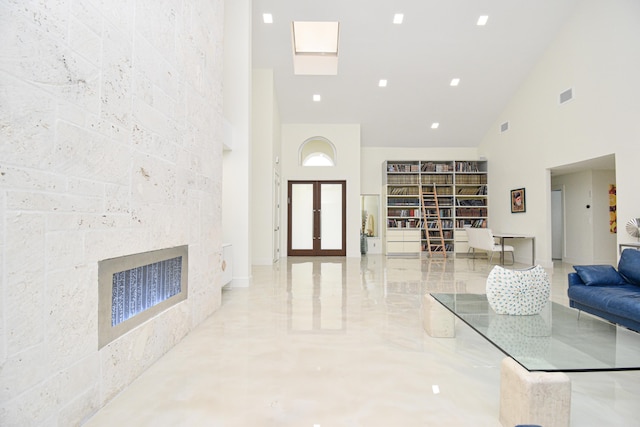 living room with visible vents and a towering ceiling