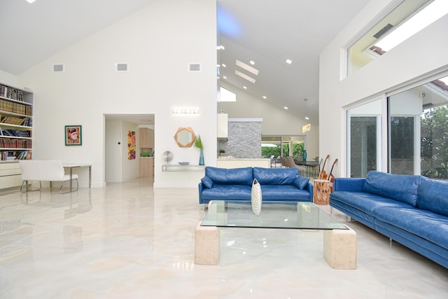 living room with visible vents, marble finish floor, and a towering ceiling