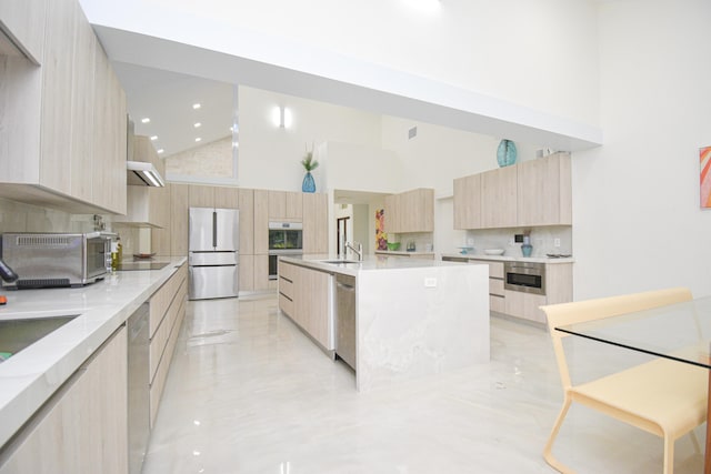 kitchen with a sink, stainless steel appliances, modern cabinets, and light brown cabinets