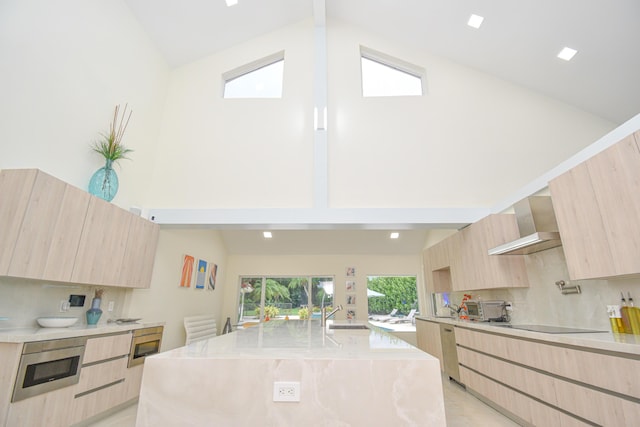 kitchen featuring light brown cabinetry, black electric stovetop, modern cabinets, and wall chimney range hood