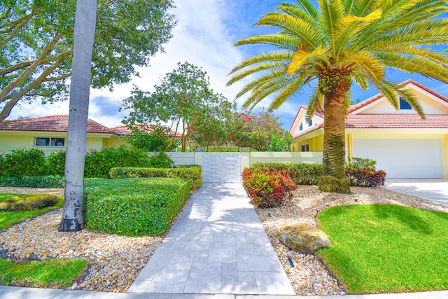 view of property's community with a fenced front yard and a garage