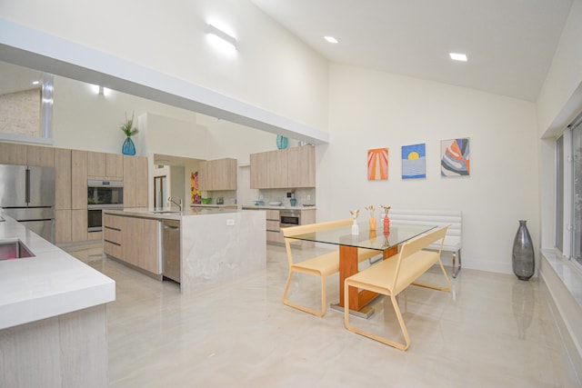 dining area featuring baseboards and high vaulted ceiling