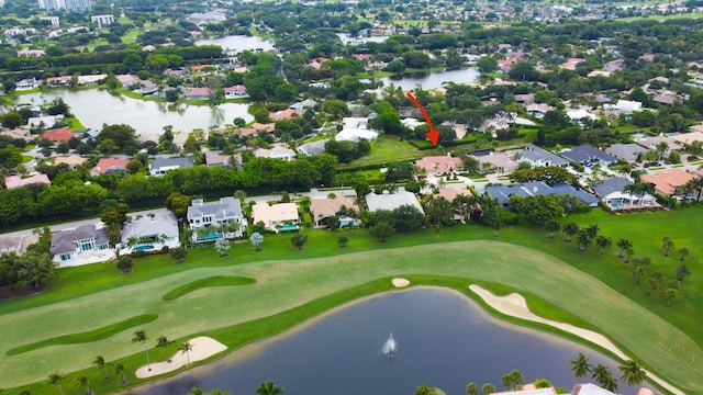 birds eye view of property featuring a water view and view of golf course