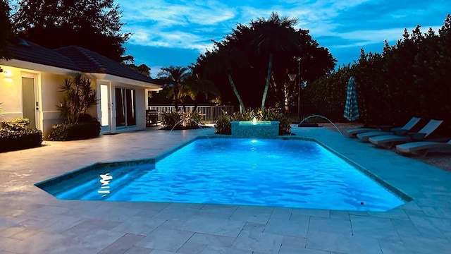 view of pool with a fenced in pool, fence, and a patio area