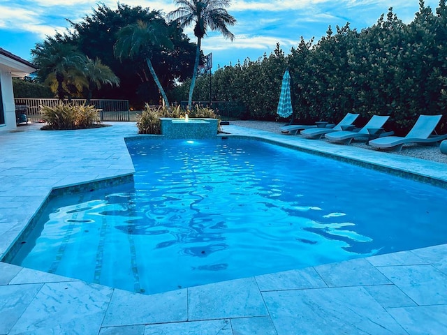 view of swimming pool featuring a fenced in pool, a patio area, and fence