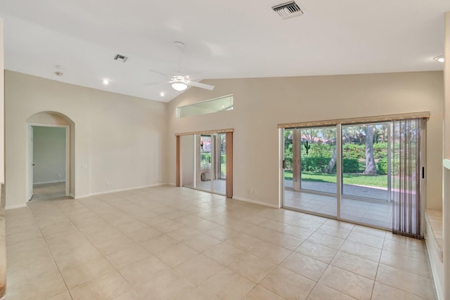 empty room with ceiling fan, vaulted ceiling, visible vents, and arched walkways