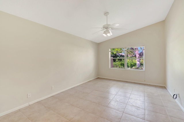 unfurnished room with vaulted ceiling, ceiling fan, baseboards, and light tile patterned floors