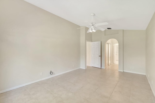 unfurnished room with arched walkways, ceiling fan, lofted ceiling, visible vents, and baseboards