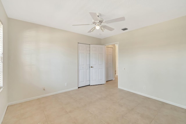 unfurnished bedroom featuring a ceiling fan, baseboards, visible vents, and a closet