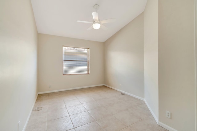 unfurnished room with lofted ceiling, light tile patterned floors, baseboards, and a ceiling fan