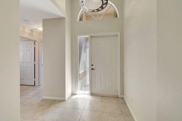 entrance foyer with light tile patterned floors and baseboards