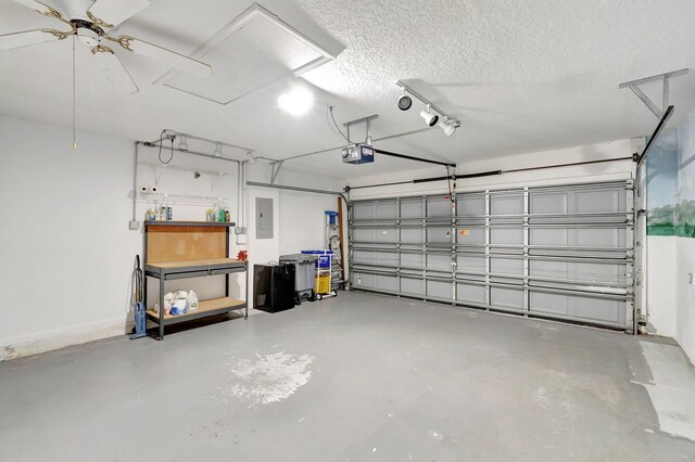 garage with ceiling fan, electric panel, baseboards, and a garage door opener