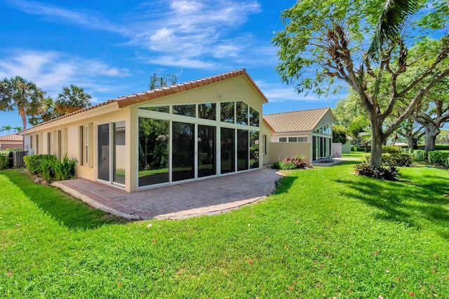 rear view of house featuring a patio area, cooling unit, and a yard