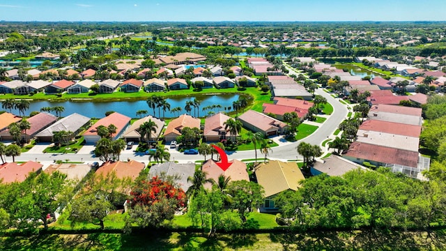 drone / aerial view featuring a residential view and a water view