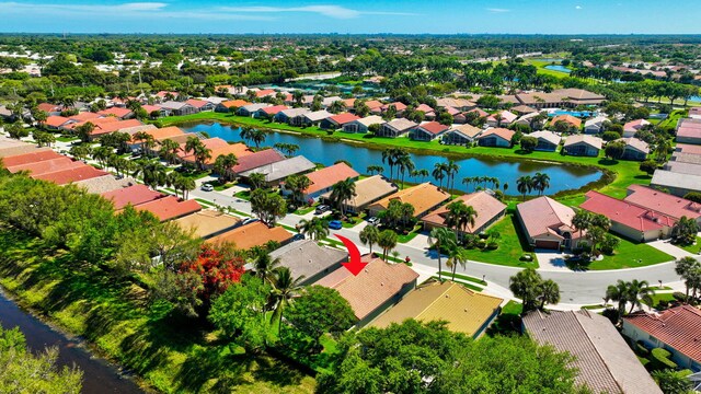 drone / aerial view featuring a water view and a residential view