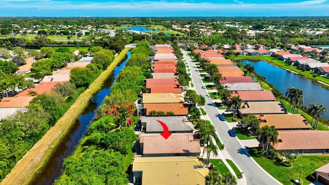 drone / aerial view with a water view and a residential view