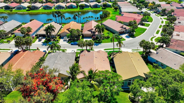 drone / aerial view with a water view and a residential view