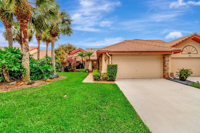 mediterranean / spanish-style house featuring stucco siding, a tile roof, concrete driveway, an attached garage, and a front yard