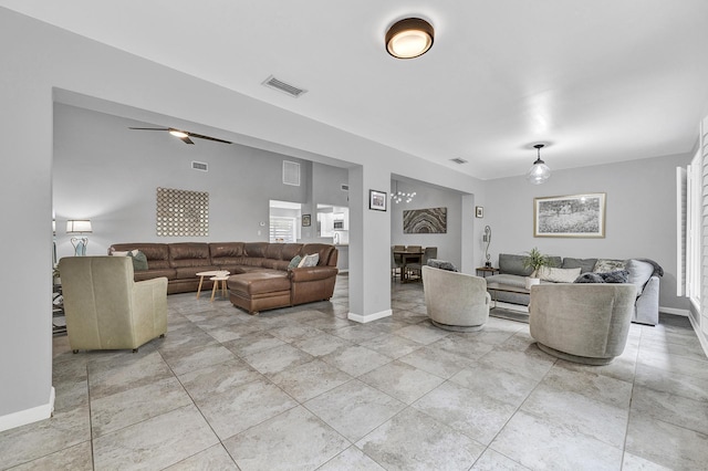 living area featuring visible vents, ceiling fan, and baseboards