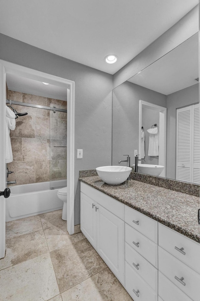 bathroom featuring vanity, toilet, and bathtub / shower combination