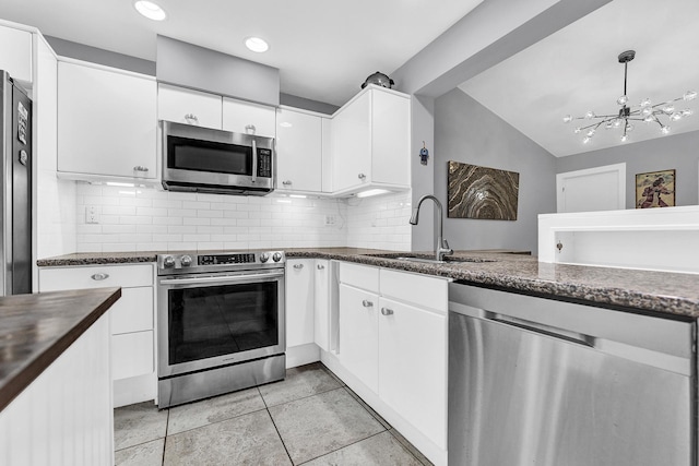 kitchen featuring a sink, decorative backsplash, a chandelier, and stainless steel appliances