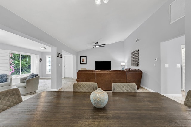 dining room featuring light tile patterned floors, baseboards, visible vents, ceiling fan, and vaulted ceiling