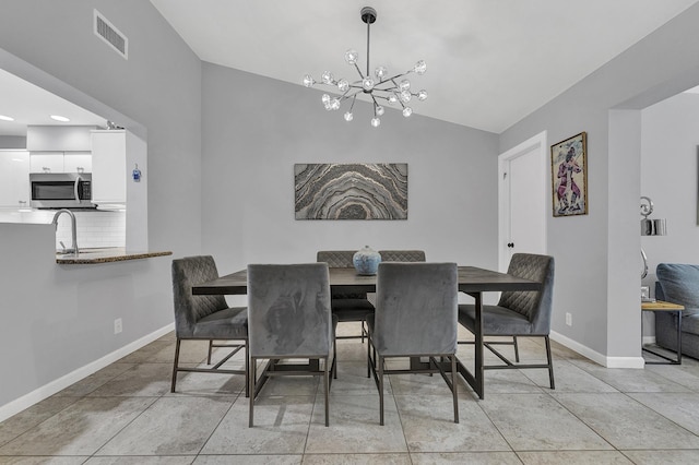 dining room featuring visible vents, lofted ceiling, an inviting chandelier, light tile patterned floors, and baseboards