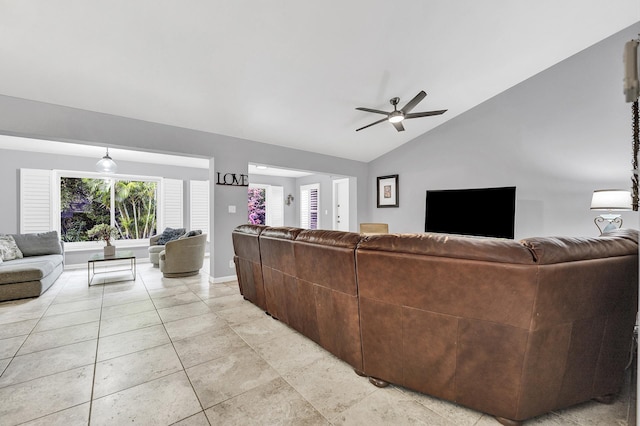 living area featuring light tile patterned floors, baseboards, lofted ceiling, and a ceiling fan