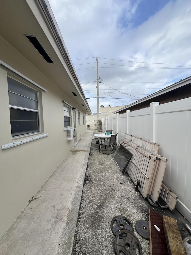 exterior space with a patio area, a fenced backyard, and stucco siding