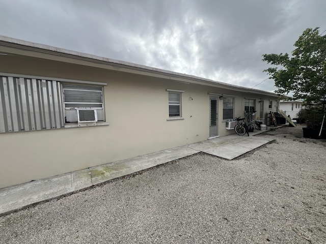 back of house featuring a patio area and stucco siding