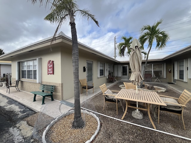 back of house featuring a patio and stucco siding