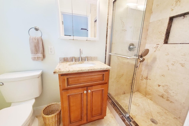 full bathroom with toilet, a shower stall, and vanity