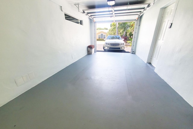 garage with visible vents and a garage door opener