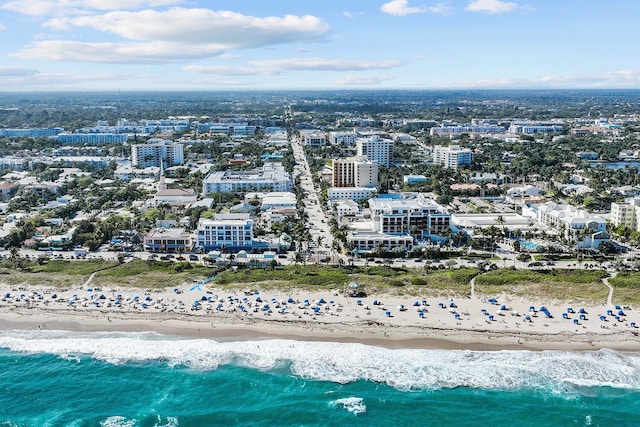 aerial view with a city view, a view of the beach, and a water view