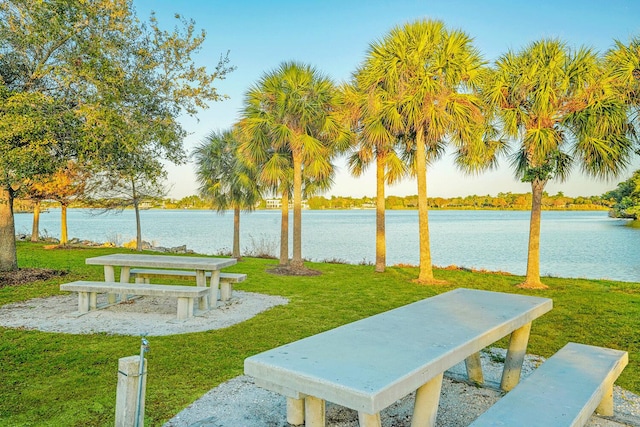 view of community featuring a water view and a lawn