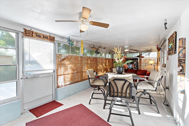 sunroom / solarium with a ceiling fan and a healthy amount of sunlight