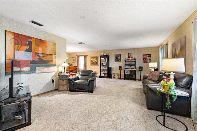 living area with visible vents, carpet floors, and a textured ceiling