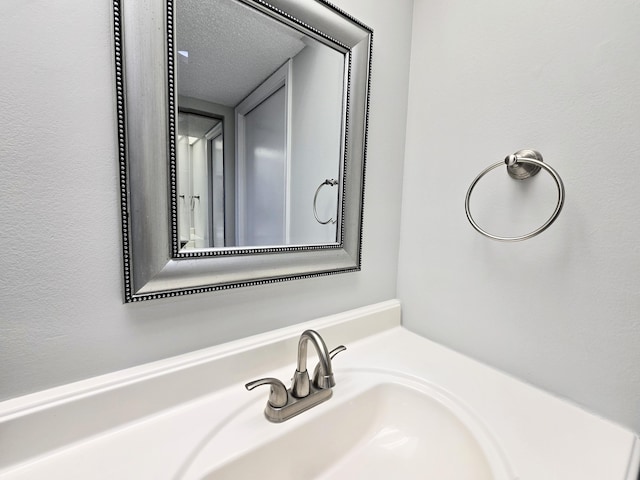 bathroom featuring a textured ceiling and vanity