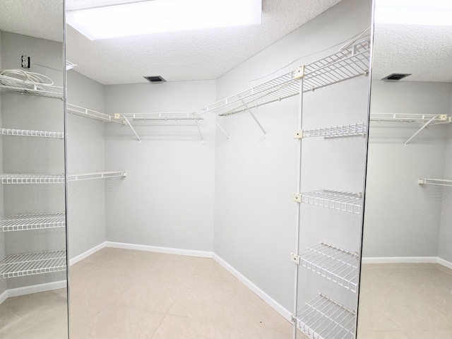 walk in closet with visible vents