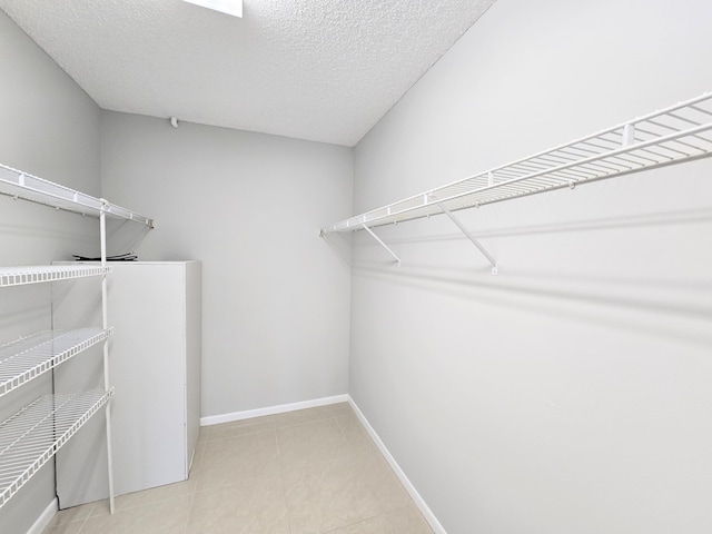 walk in closet with tile patterned floors