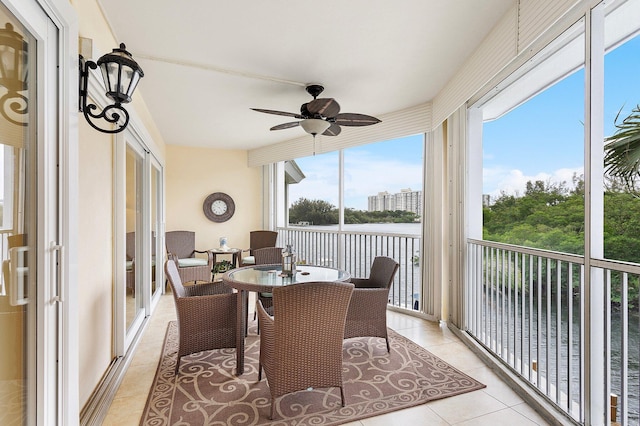 sunroom / solarium featuring ceiling fan