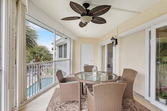 sunroom / solarium featuring ceiling fan